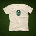 Ivory t-shirt with a green Eternal Optimist Golf Club logo. 