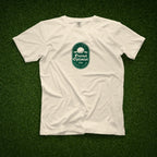 Ivory t-shirt with a green Eternal Optimist Golf Club logo. 