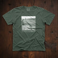 Dark green t-shirt that has an image of a golfer with a quote from Ben Hogan: "The most important shot in golf is the next one."