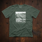 Dark green t-shirt that has an image of a golfer with a quote from Ben Hogan: "The most important shot in golf is the next one."