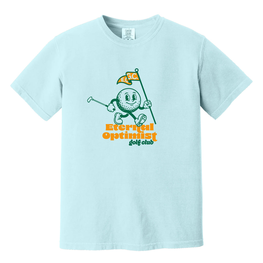 Light blue t-shirt with a 1950s-inspired golf ball cartoon that has legs and arms. He is carrying a putter and a flagstick that has "E.O.G.C." on the flag. Below him are the words 'Eternal Optimist Golf Club'.