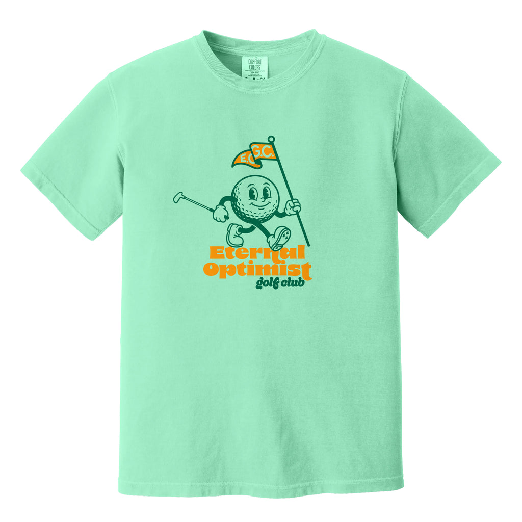 Light green t-shirt with a 1950s-inspired golf ball cartoon that has legs and arms. He is carrying a putter and a flagstick that has "E.O.G.C." on the flag. Below him are the words 'Eternal Optimist Golf Club'.