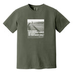 Mossy green t-shirt that has an image of a golfer with a quote from Ben Hogan: "The most important shot in golf is the next one."
