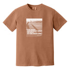 Dark orange t-shirt that has an image of a golfer with a quote from Ben Hogan: "The most important shot in golf is the next one."